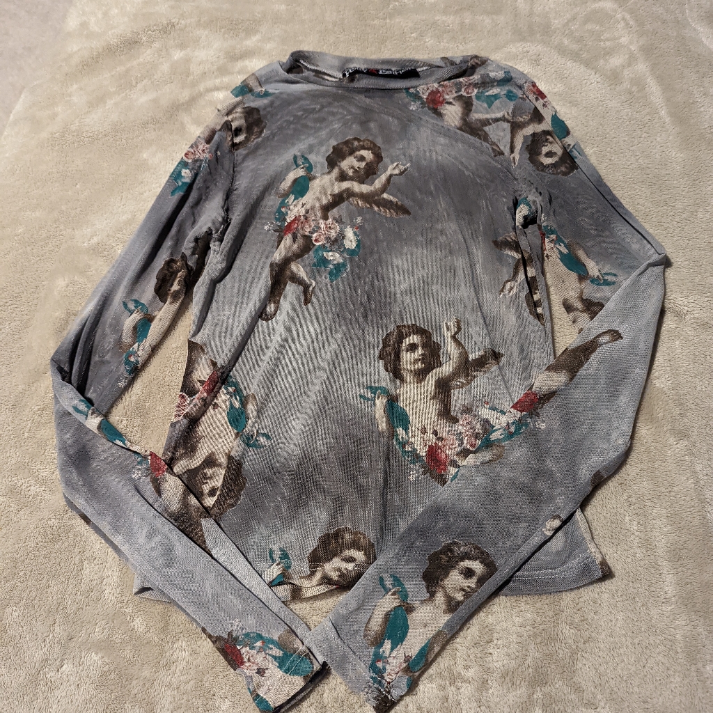 A mesh or fishnet top photographed for a US retail listing in September 2026